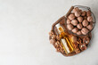© Pixel-Shot - Bottle of fresh walnut oil and basket with nuts on white background