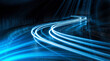 © Jacqueline - Abstract long exposure photograph of vibrant blue light trails curving sharply on a dark, wet road, symbolizing speed.