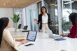 © Wavebreak Media - Diverse women team presenting sales figures on whiteboard in meeting room with marker, copy space