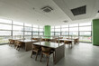 © zhu difeng - Modern office space with large windows and neatly arranged reading tables and chairs
