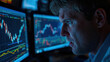 © siraphol - Man watching volatile stock charts on multiple monitors with concerned expression