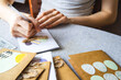 © Ina - Young teenage girl making handmade greeting easter cards at home for school volunteer project. She writing message on card DIY craft activity for holidays, creativity, education and charity concept