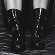 © Kanok - A stylish pair of shiny black patent leather fashion boots