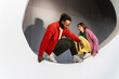 © Westend61 - Fashionable pair posing beside a white circle outdoors