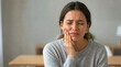 © Xenia - Young woman suffering from severe toothache holding her jaw. Facial pain and dental health problems. Person in distress at home