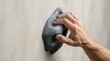 © Helen - Close-up of a climber's hand gripping a hold on an indoor climbing wall