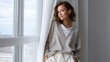 © Isoon - Serene contemplation by the window: A portrait of a woman radiating tranquility and introspection as she leans against a window. The soft light of the day gently caresses her face.