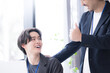 © kapinon - 会社の仕事中に上司に励まされる新卒などの新入社員の爽やかなイメージ　その調子！仕事頑張ってね！OJTで先輩に指導を受ける若手社員の成長と教育のビジネスシーン