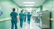 ©  S u n n y B u n n y - Medical staff in teal scrubs walking through a hospital hallway during a busy night shift nursing rotation