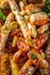 © zukamilov - Grilled sausages with chili peppers and herbs close up