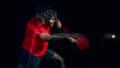 © Lustre Art Group  - Table tennis player reacting to fast ball with motion blur in dark studio. Concept of reaction speed training, reflex development, quick response ability and athletic performance improvement.