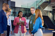 © Rido - Happy multiethnic business team talking together in office lobby