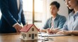© kusyanto - Real Estate Agent Discussing Property with Clients.