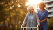 © Lemonkey - Elderly woman walking outdoors with a walker assisted by a female caregiver, showing support, mobility, and compassionate healthcare in a natural setting.