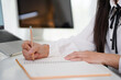 © Stella 16 - Corporate asian woman, notebook and writing in planning, schedule or strategy for job as receptionist. Woman, professional and laptop on table by book, working or thinking of idea for research notes