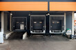 © R_Yosha - Loading dock or loading bay with bumpers, levelers, lift, dock seals or shelters, traffic lights. Loading bay is area of building where goods vehicles road or rail are loaded and unloaded.