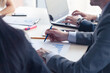 © alotofpeople - A business leader at a table looks at a chart