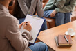© Pixel-Shot - Male family mediator working with lesbian couple in office, closeup