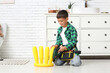 © Pixel-Shot - Cute little happy handyman with electric drill assembling chair in bathroom