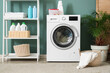 © Pixel-Shot - Interior of laundry room with washing machine, shelf unit and palm plant