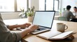 © Achmad Agus Ilyas - Person Typing on Laptop in Bright Office