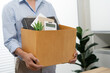 © Charlie's - Business man sending resignation letter and packing Stuff Resign Depress or carrying business cardboard box by desk in office. Change of job or fired from company
