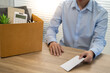 © Charlie's - sending resignation letter to boss and Holding Stuff Resign Depress or carrying cardboard box by desk in office