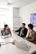 © fizkes - Diverse business team discussing financial strategy, collaborating on documents, reviewing sales report statistics, listening leader explaining data during teamwork in conference room. Management