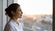 © Teeradej - Mental wellness, depression. Thoughtful middle age woman gazing outside with serene expression