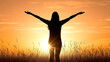 © Artsaba Family - Silhouette of female in field with sunrise and outstretched arms
