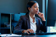 © Seventyfour - Black young adult businesswoman working at desktop computer in office, reviewing information and planning strategy. Ideal for corporate leadership, career growth, productivity marketing