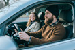 © AnnaStills - Young adult man driving car with smiling teenage girl riding in passenger seat, showing family travel and safe transportation. Useful for insurance, driving school, mobility or parenting campaigns
