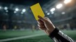 © Javid - Close up of a soccer referee hand holding a yellow card in stadium. AI generated image
