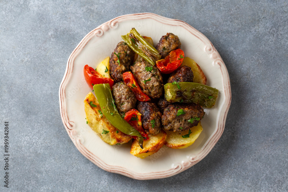 Photo Stock Turkish style baked meatballs and potatoes with roasted ...
