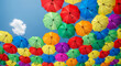 © PhotoArtHub - Many colorful umbrellas against a bright blue sky, representing joy, protection, or celebration of life and resilience under changing weather