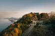 © AmazingAerialAgency - Aerial view of the Takaya Shrine's stairway and torii gate atop a mountain, where the sea meets the sky in ethereal hues, Kanonji, Kagawa, Japan.