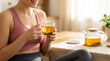 © Tomo - Woman in fitness wear drinking herbal tea for wellness and healthy lifestyle recovery