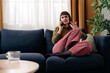 © MexChriss - Woman experiencing frustration talking on phone at home