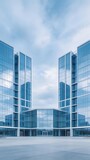 Modern glass office buildings with reflective facades under a cloudy sky