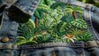 © Future Vision - Displaying embroidered tropical panel on denim jacket on flat surface, highlighting metal snaps