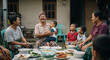 © Bang_Roz - A happy multi-generational Indonesian family sharing a traditional meal outdoors, laughing and bonding together in a rural village setting.