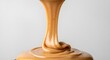 © amera - Creamy smooth peanut butter dripping in a thick, continuous swirl against a clean, minimal light gray background.