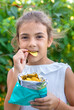 © yanadjan - The child is eating chips. Selective focus.