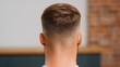 © Brera Design - A close-up view of the back of a man's head showcasing a fresh, clean fade haircut with a smooth gradient from short to longer hair.