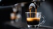 © dmmarychev - Espresso pouring from coffee machine into clear glass cup with crema