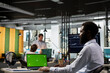 © DC Studio - Black male employee analyzing business data on laptop with blank mockup template. African American finance analyst in modern workspace using digital device with green screen display.
