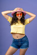 © Guillermo Spelucin - Young woman smiling in colorful summer fashion