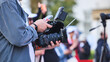 © Довидович Михаил - Cameraman filming video with professional camera and accessories for media production
