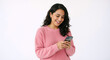 © Vyatcheslav - Happy young woman smiling at smartphone screen. Female in pink sweater using mobile phone against white background. Digital communication and joy concept