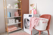 © Pixel-Shot - Interior of laundry room with washing machine, shelf unit and chair